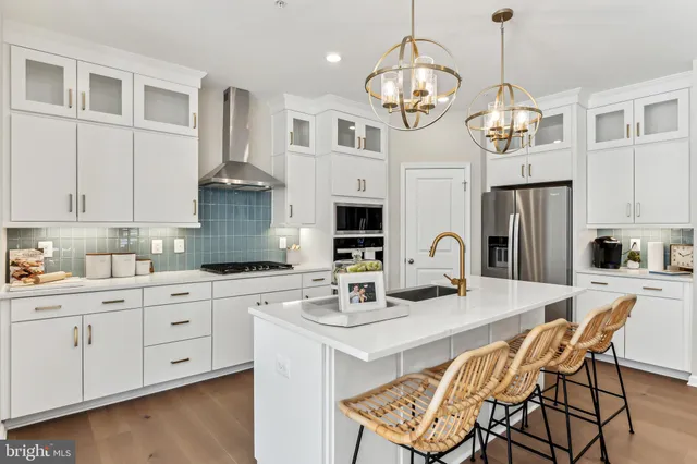 a kitchen with stainless steel appliances granite countertop a stove and a sink