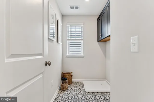 a view of a bedroom with wooden floor and furniture