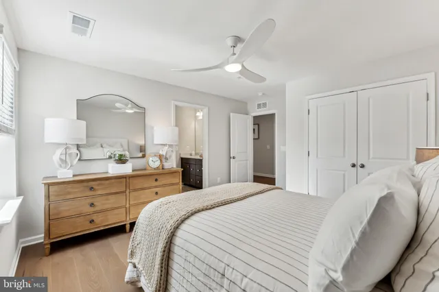 a bedroom with a bed and ceiling fan