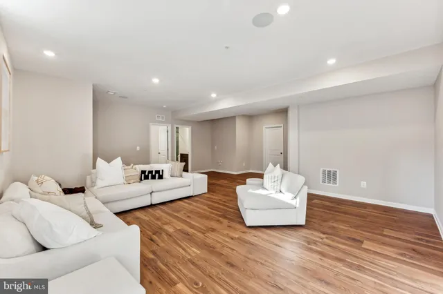 a room with a bed and a wooden floor