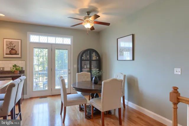 a large kitchen with stainless steel appliances granite countertop a stove a sink dishwasher a microwave oven and a refrigerator with wooden cabinets