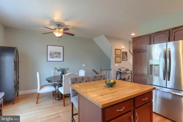 a view of a kitchen that has a dining table and chairs