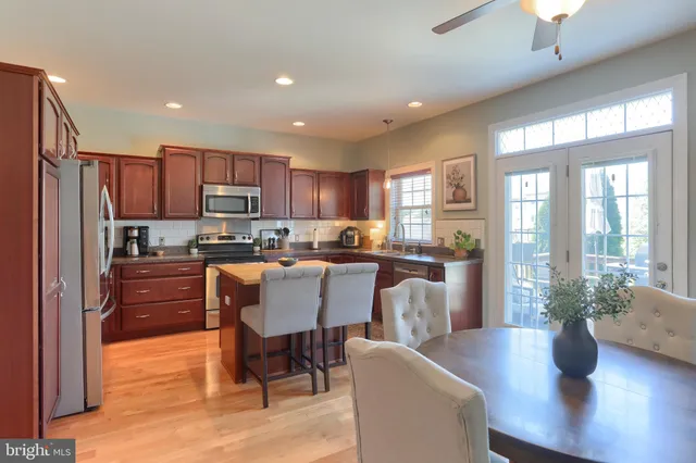 a view of a dining room with furniture a chandelier and wooden floor