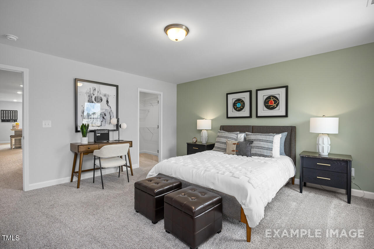 409 Grading Stick Court Angier, NC 27501 - Photo 31 of 52 a bedroom with a bed and a chair