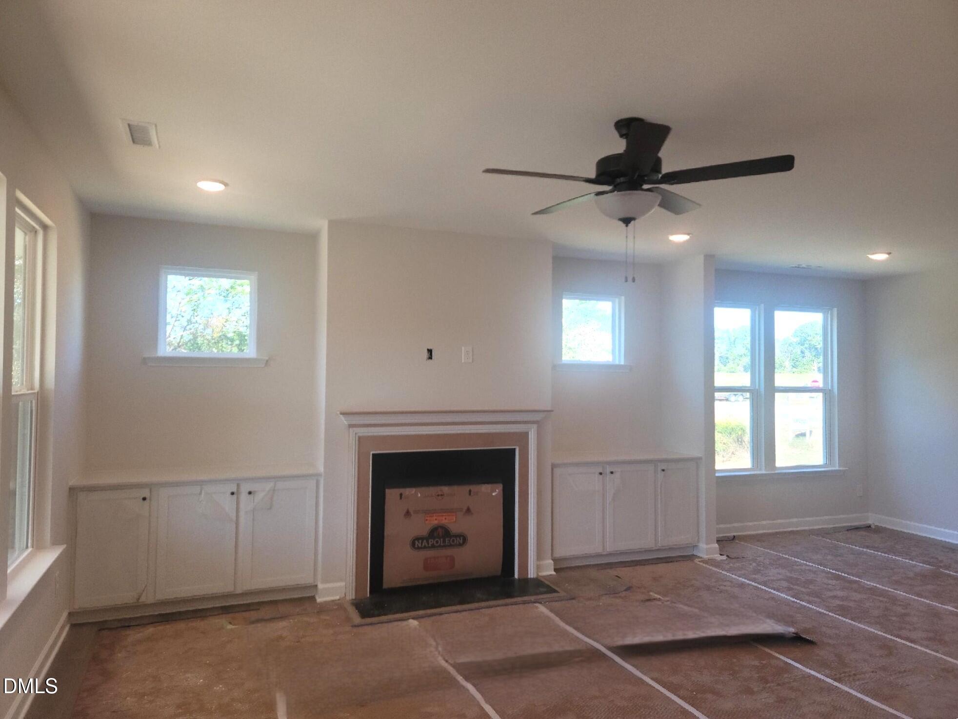 409 Grading Stick Court Angier, NC 27501 - Photo 45 of 52 a view of an empty room with window and fireplace