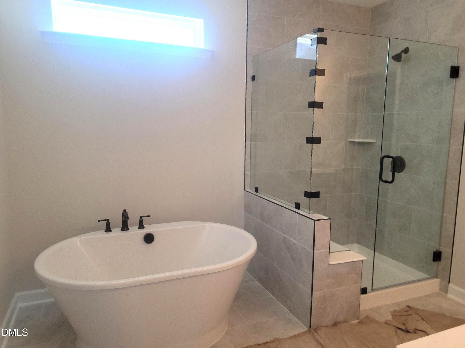 409 Grading Stick Court Angier, NC 27501 - Photo 48 of 52 a white bath tub sitting next to a bathroom