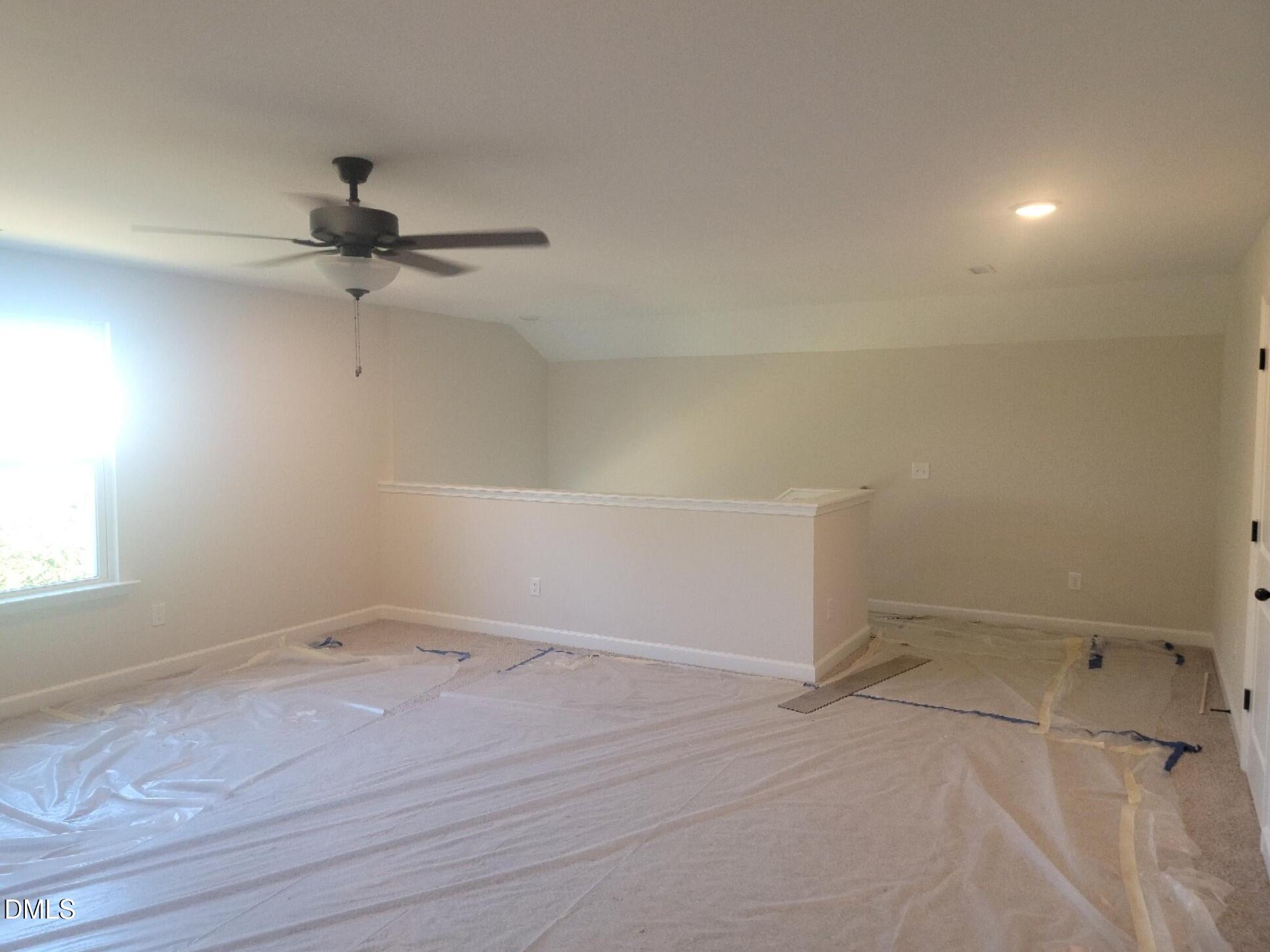 409 Grading Stick Court Angier, NC 27501 - Photo 49 of 52 an empty room with a ceiling fan and window