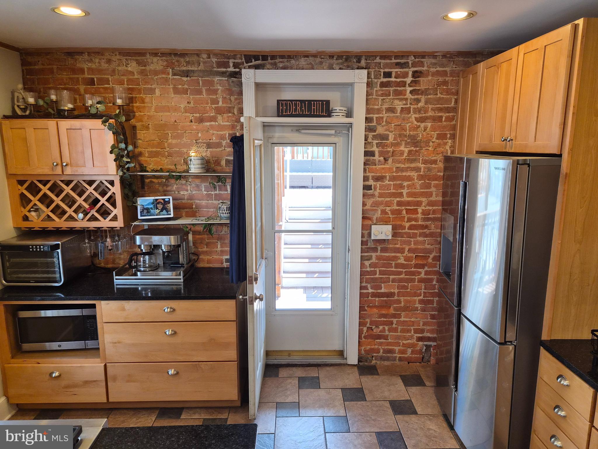 1601 Belt Street Baltimore, MD 21230 - Photo 7 of 30 a kitchen with stainless steel appliances granite countertop a refrigerator and a stove