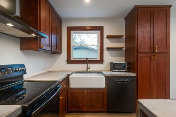 a kitchen with a sink stove and cabinets