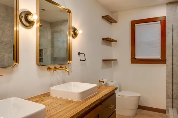 a bathroom with a sink a toilet and mirror
