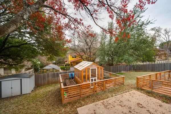 a view of a balcony with wooden floor and fence