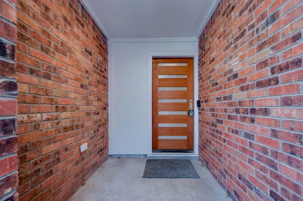a view of an empty room and wooden floor