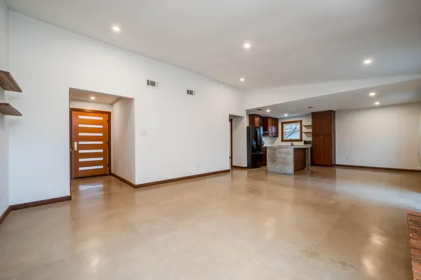 an empty room with a kitchen and a sink