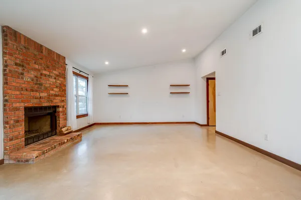 a view of an empty room with a fireplace