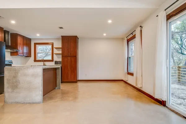 a view of kitchen with stainless steel appliances granite countertop a refrigerator and a sink