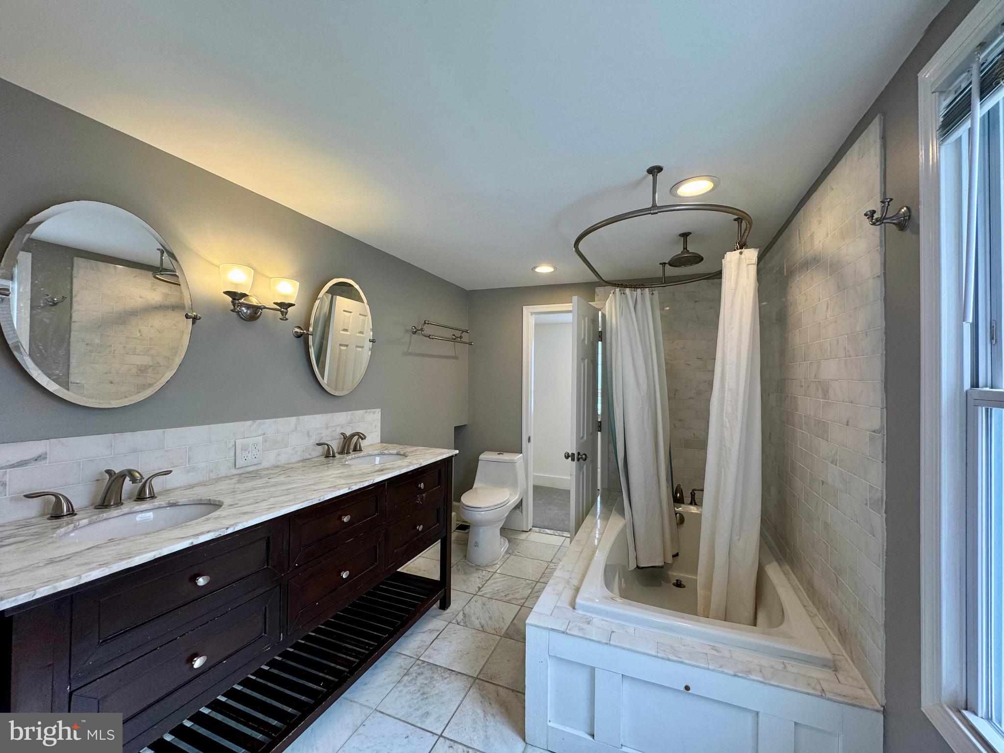 1313 Patapsco Street Baltimore, MD 21230 - Photo 15 of 20 a bathroom with a double vanity sink mirror and shower