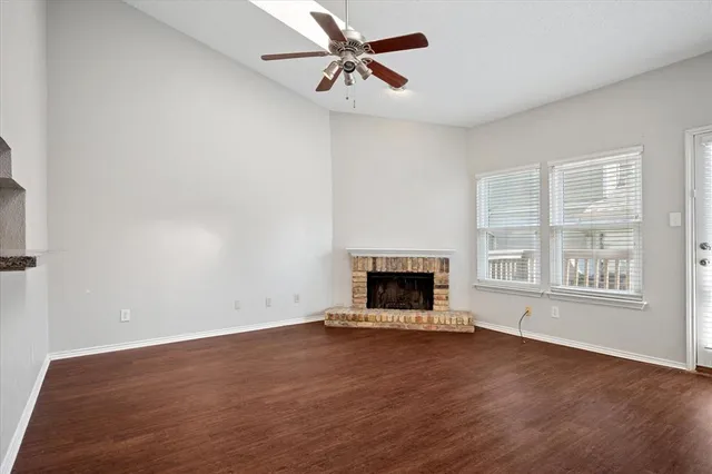 an empty room with a fireplace and a window