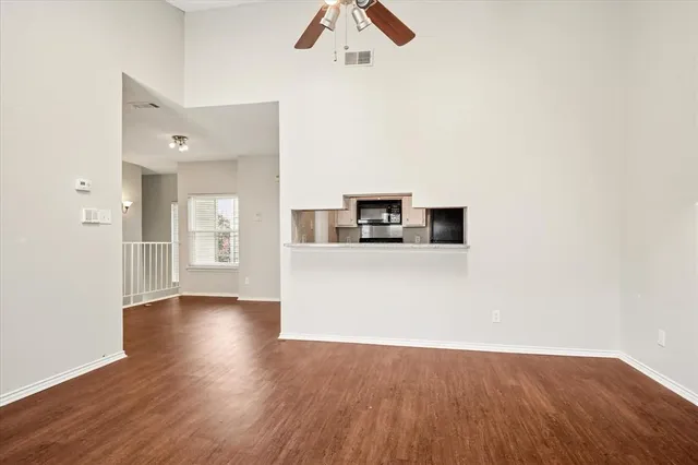 a view of a kitchen with a sink and a refrigerator