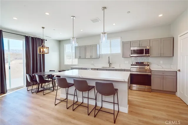 a kitchen with a table chairs microwave and cabinets