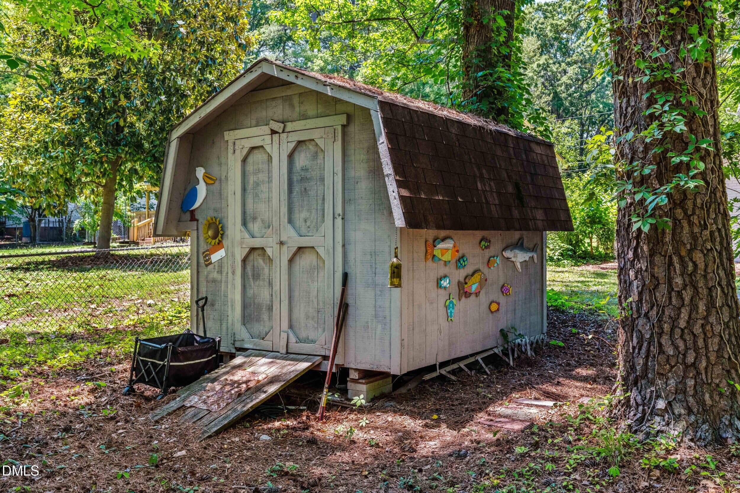3724 Randell Road Garner, NC 27529 - Photo 29 of 32 a view of a small house with a yard and large trees