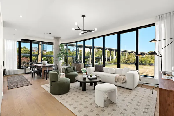 a living room with furniture and large windows