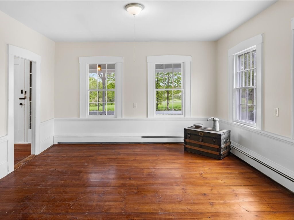 5 Northeast Fitzwilliam Road Royalston, MA 01368 - Photo 15 of 37 an empty room with wooden floor and windows