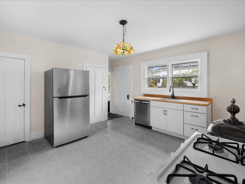 5 Northeast Fitzwilliam Road Royalston, MA 01368 - Photo 25 of 37 a kitchen with a refrigerator and a stove top oven