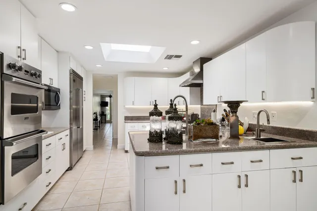a kitchen with counter top space cabinets and stainless steel appliances