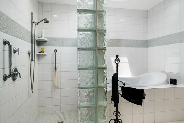 a bathroom with a bathtub and shower