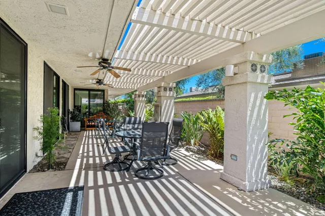 a view of a patio with table and chairs potted plants with wooden floor