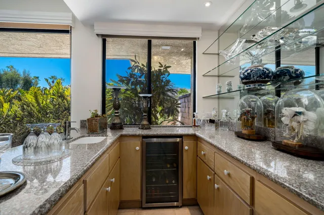 a kitchen with sink and view of living room