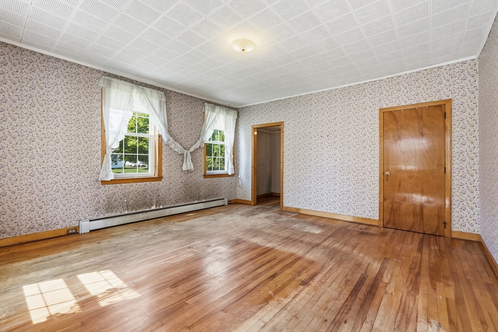 15 Main Street Hatfield, MA 01038 - Photo 6 of 42 an empty room with wooden floor and windows