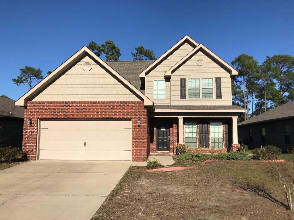 66 Pin Oak Loop Santa Rosa Beach, FL 32459 - Photo 1 of 32 a front view of a house with a yard and garage