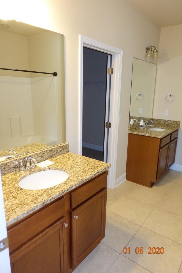66 Pin Oak Loop Santa Rosa Beach, FL 32459 - Photo 13 of 32 a bathroom with a granite countertop sink and a mirror