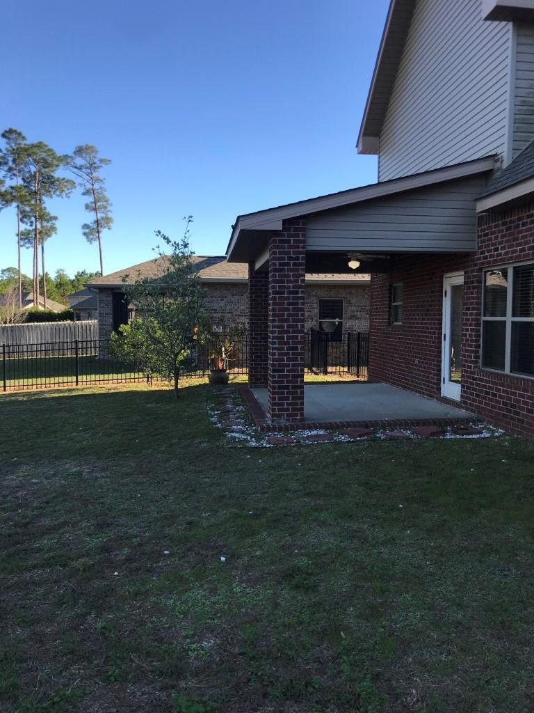 66 Pin Oak Loop Santa Rosa Beach, FL 32459 - Photo 29 of 32 a front view of a house with a garden