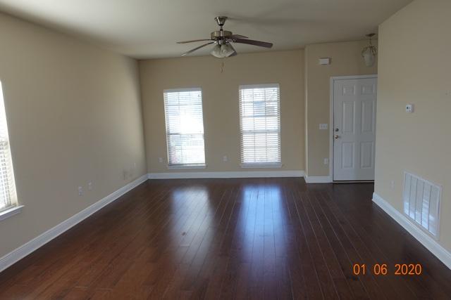 66 Pin Oak Loop Santa Rosa Beach, FL 32459 - Photo 3 of 32 an empty room with wooden floor and windows