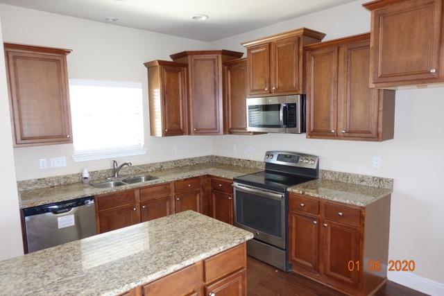 66 Pin Oak Loop Santa Rosa Beach, FL 32459 - Photo 4 of 32 a kitchen with kitchen island granite countertop wooden cabinets stainless steel appliances and a sink