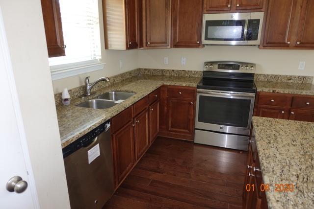 66 Pin Oak Loop Santa Rosa Beach, FL 32459 - Photo 7 of 32 a kitchen with granite countertop a sink a stove and microwave
