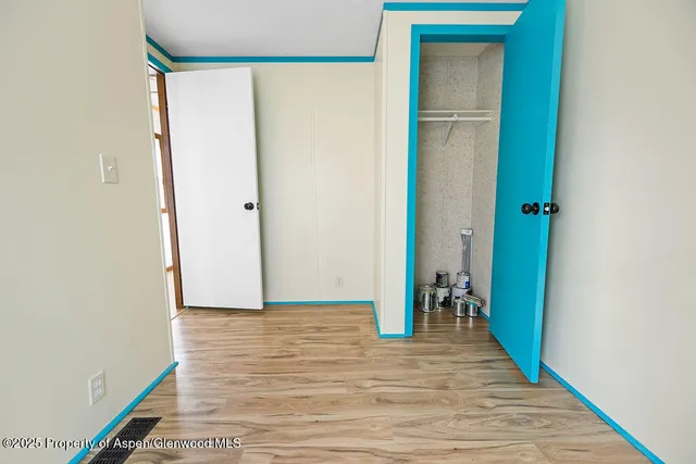 a view of a hallway with wooden floor and a hallway