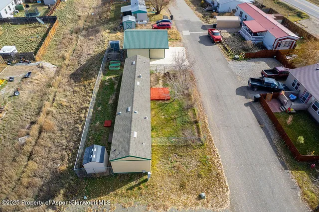 an aerial view of a house with a yard