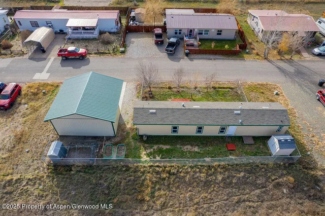 an aerial view of a house with pool table and chairs