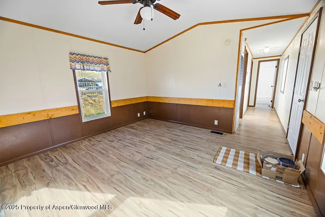 a view of an empty room with wooden floor