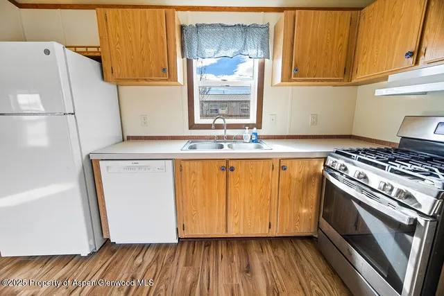 a kitchen with wooden floors and a stove