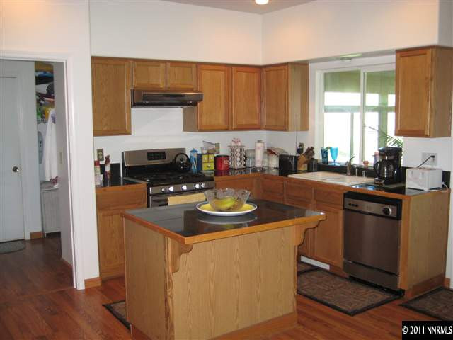 2265 Snowmass Drive Reno, NV 89511 - Photo 3 of 13 a kitchen with stainless steel appliances granite countertop a sink stove and refrigerator