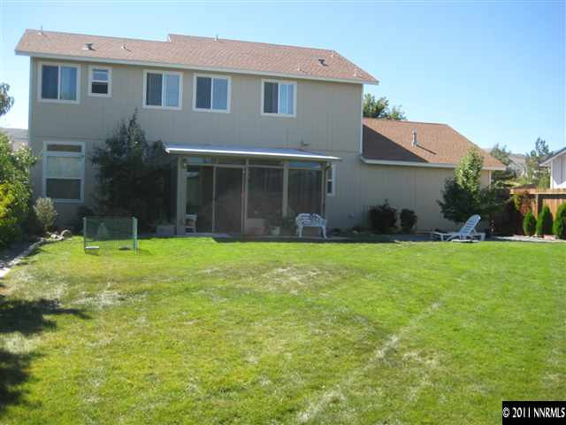 2265 Snowmass Drive Reno, NV 89511 - Photo 7 of 13 a front view of a house with a yard and garage