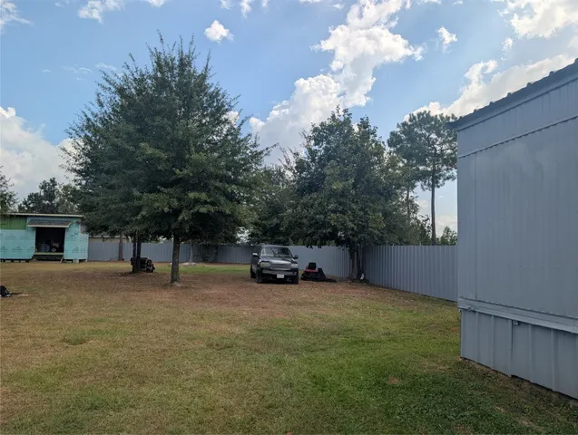 a view of a car in the back yard