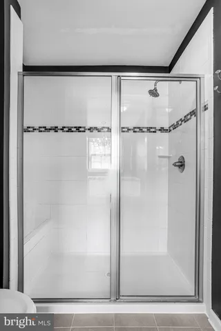 a bathroom with a glass shower door
