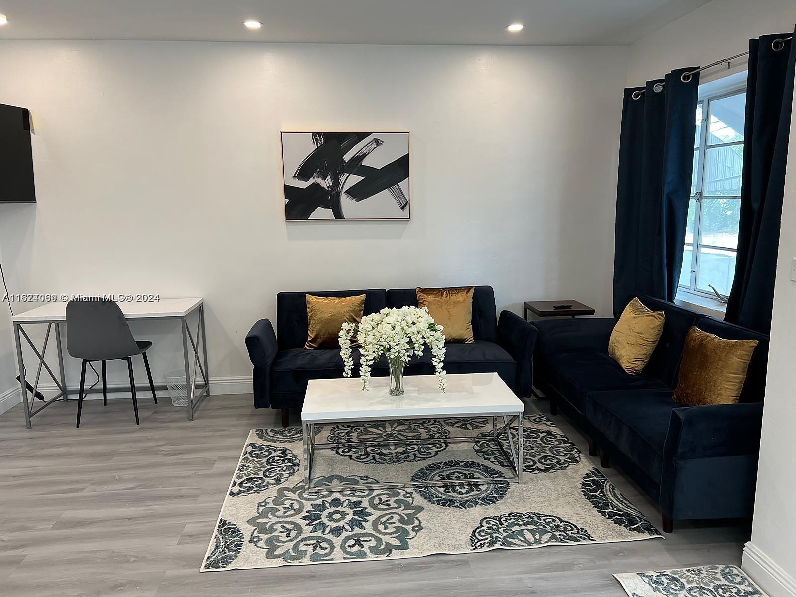 501 Northeast 70th Street, Unit 3 Miami, FL 33138 - Photo 5 of 11 a living room with furniture and a rug