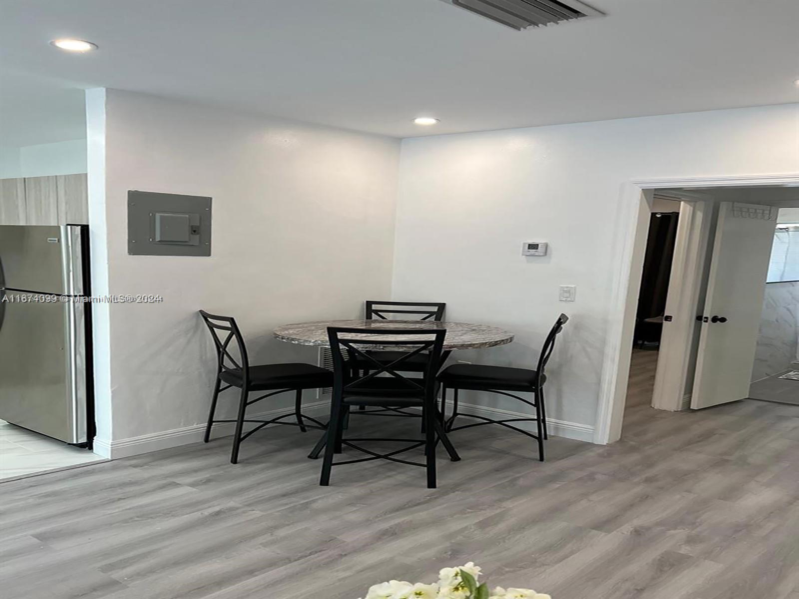501 Northeast 70th Street, Unit 3 Miami, FL 33138 - Photo 7 of 11 a view of a dining room with furniture and wooden floor