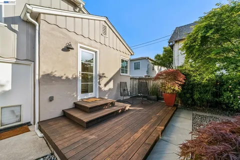 a view of house with backyard and sitting area